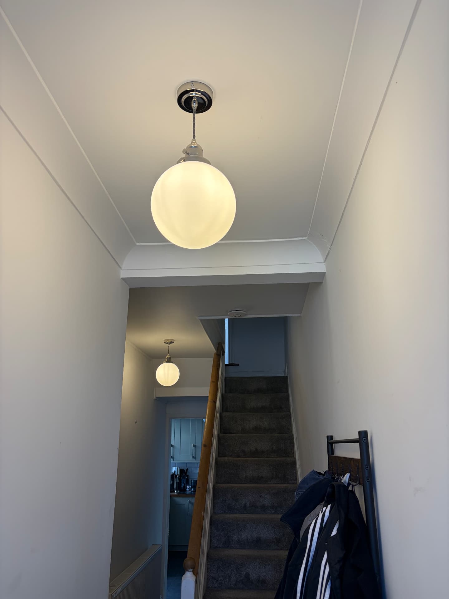 Opal globe pendant lights installed in a hallway and landing