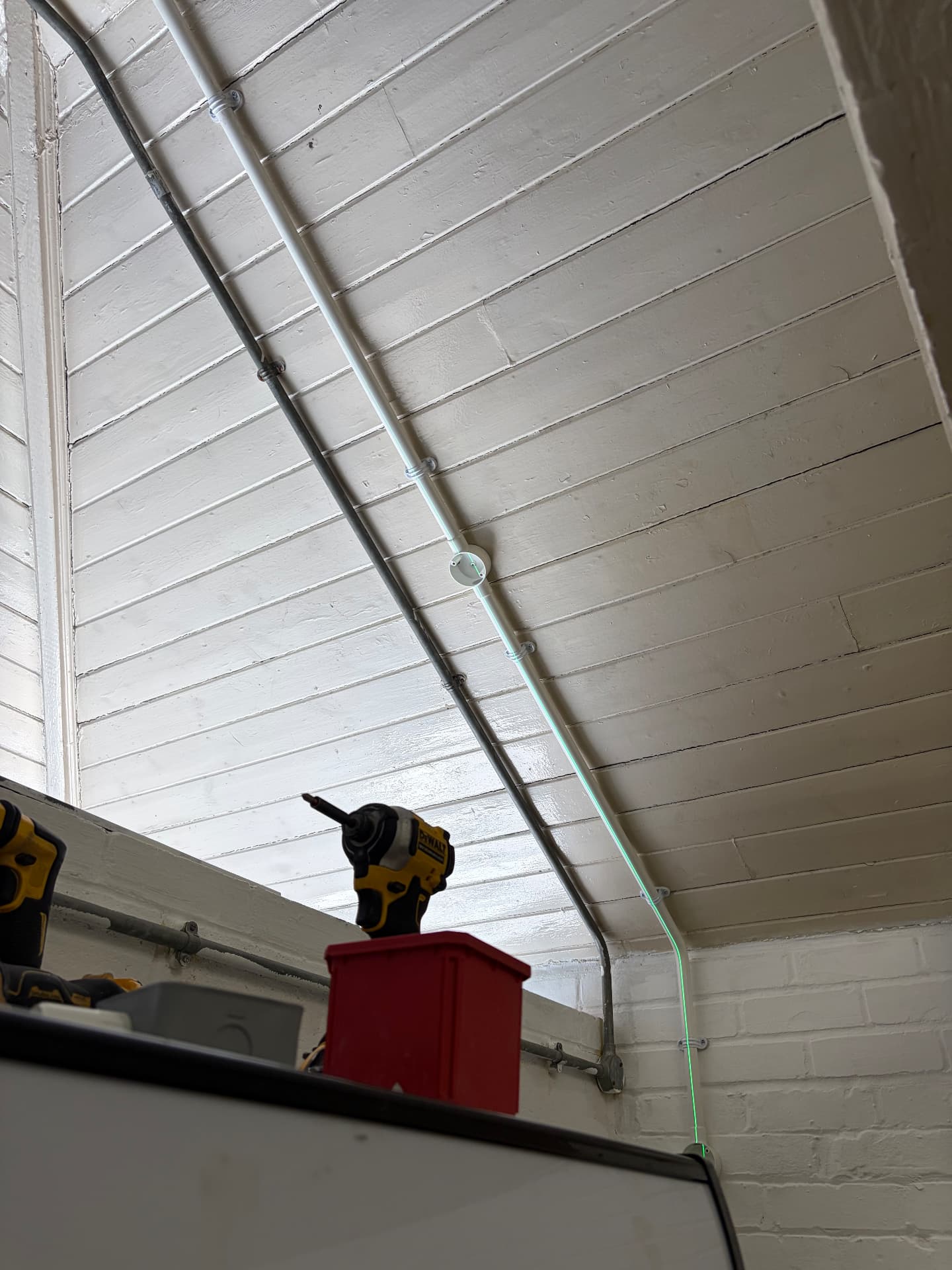 Laser level used to set out surface conduit on a commercial ceiling