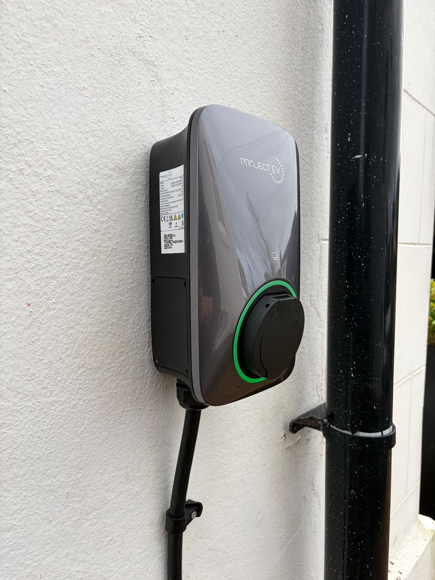 Project EV charge point installed on a rendered house wall