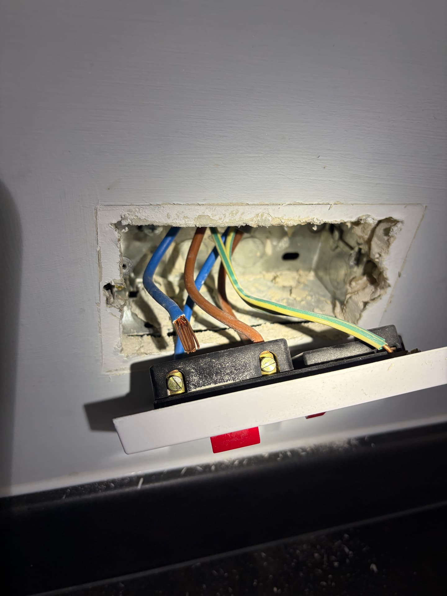 Socket removed from its back box to test the ring final circuit wiring