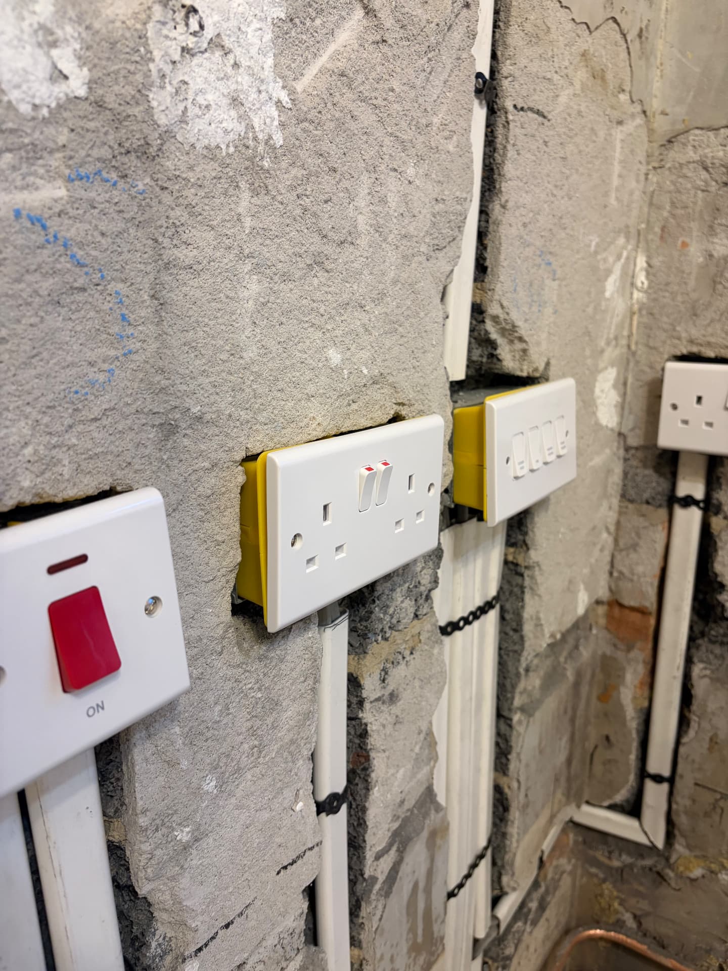 New sockets and switches chased into a wall during a house rewire