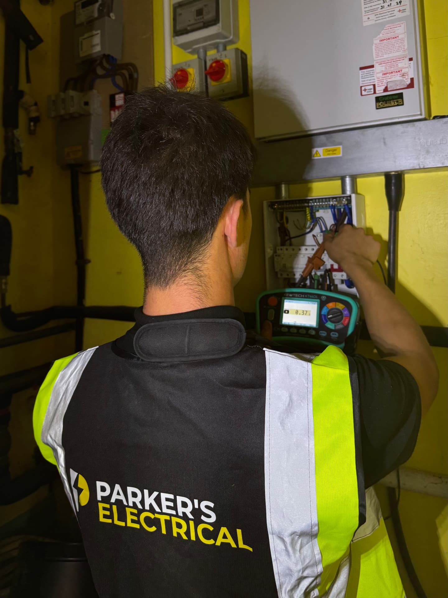 Parker's Electrical engineer testing circuits at a distribution board during an EICR