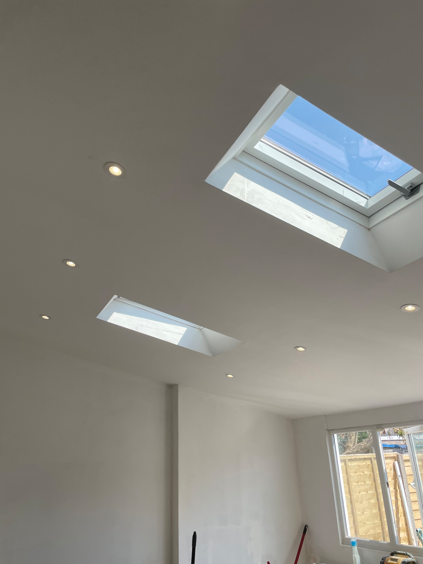 Downlights installed in a new extension ceiling alongside roof windows