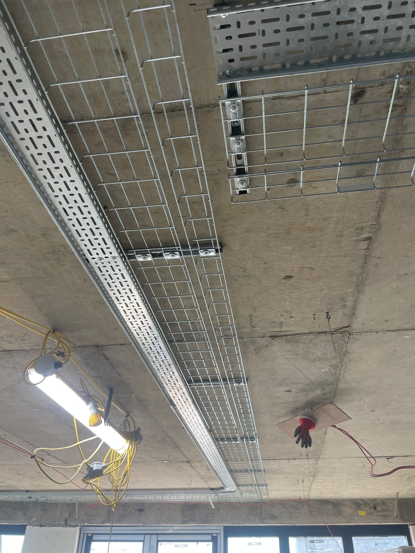 Cable tray and basket containment installed across a concrete soffit