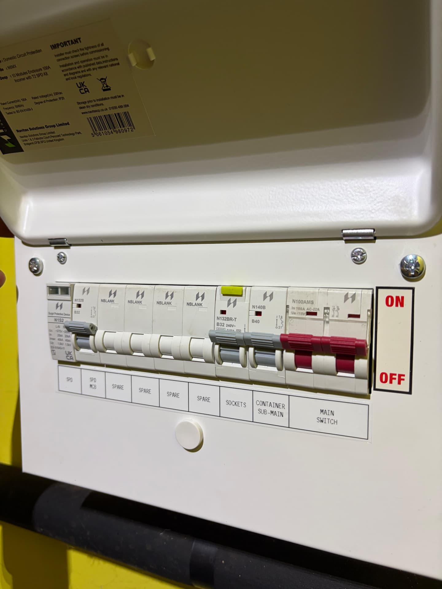 Consumer unit with surge protection feeding sockets and a container sub-main