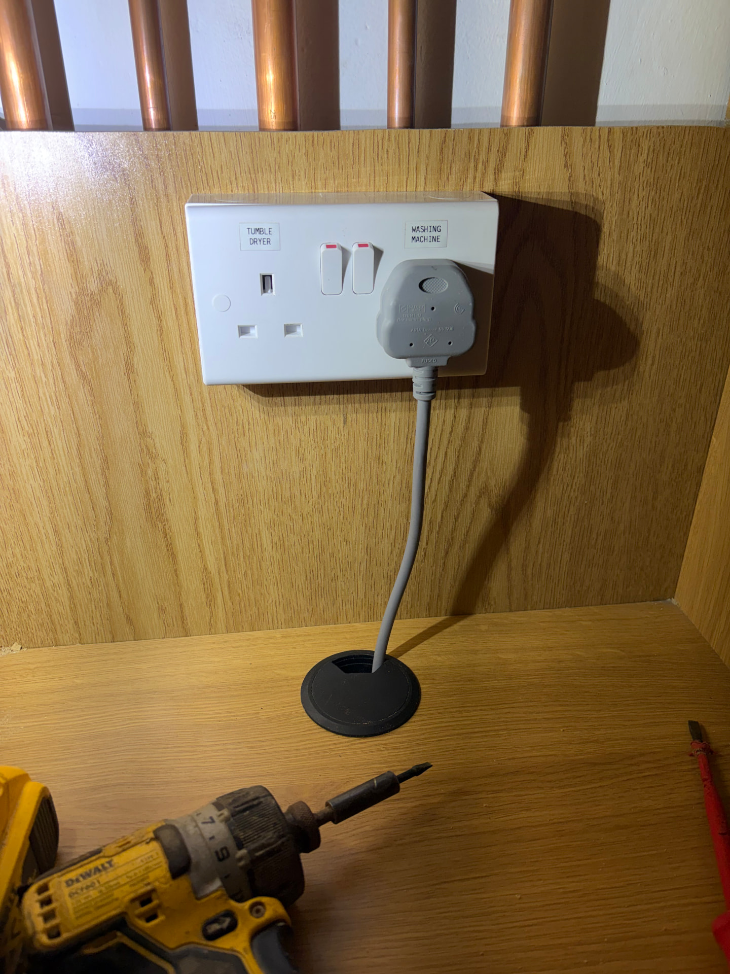 Labelled tumble dryer and washing machine appliance sockets in a utility room