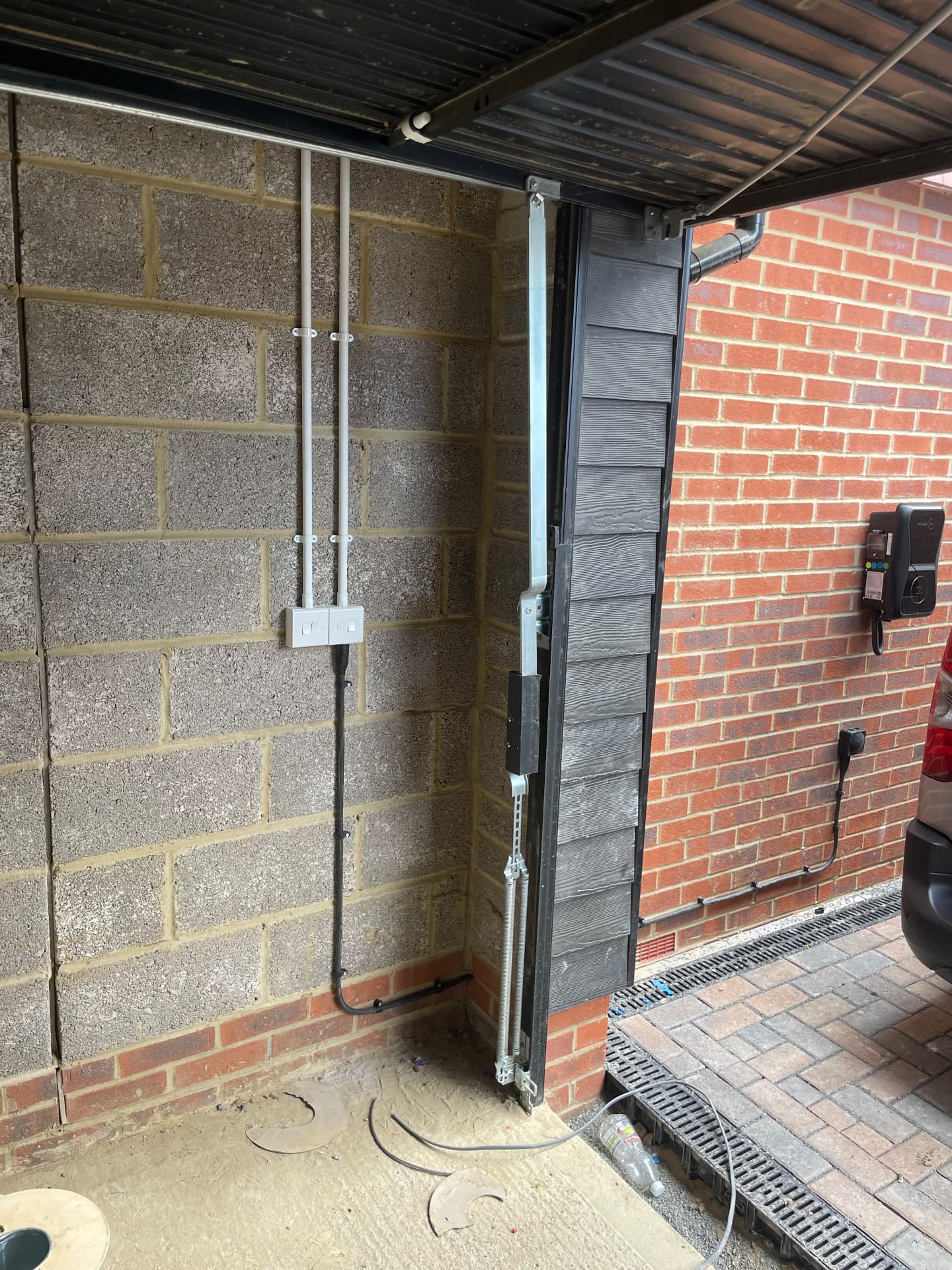 Garage sockets fed in surface conduit alongside an EV charger installation