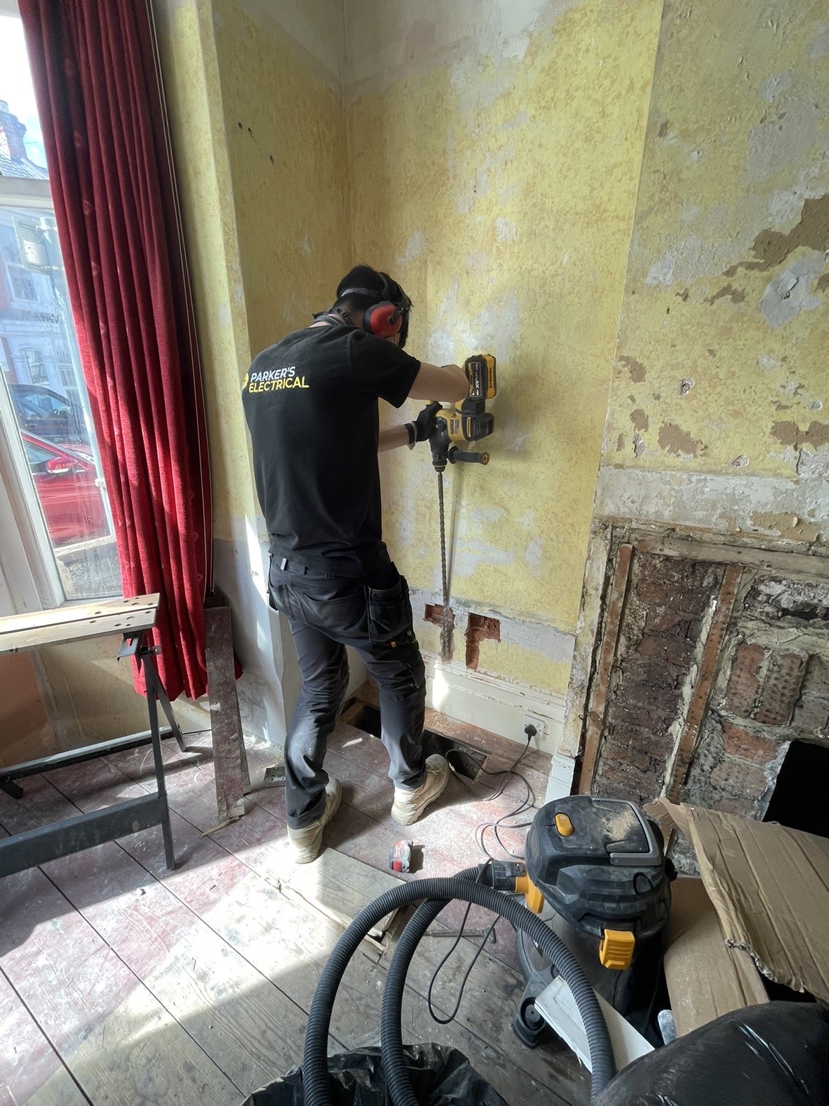 Electrician drilling a wall during a full house rewire in Southampton