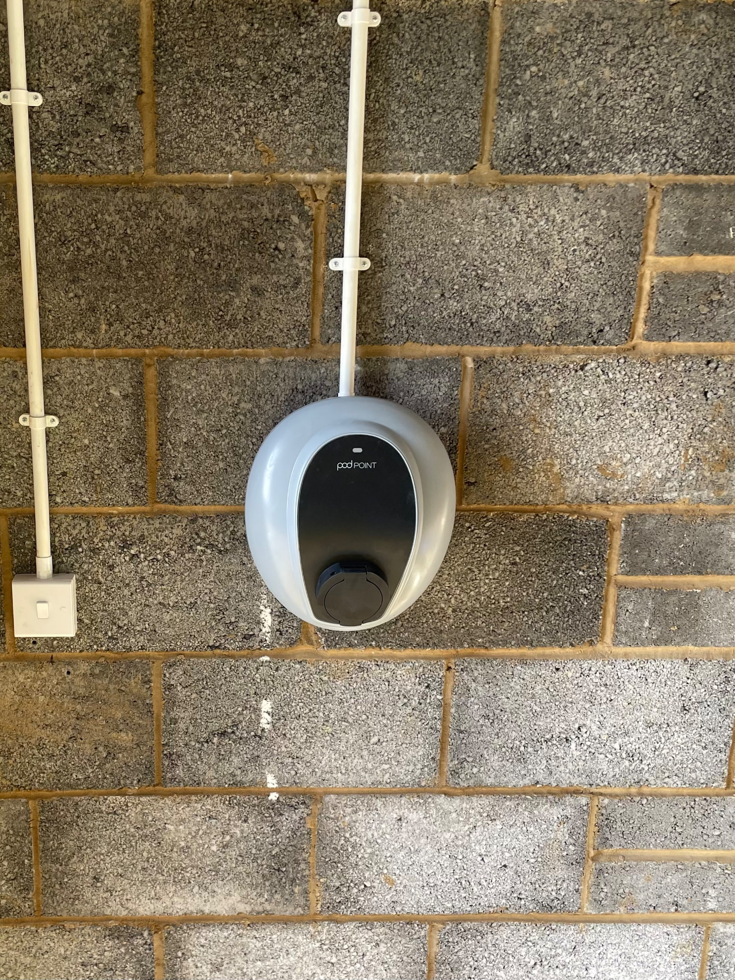 Pod Point EV charger installed in a Southampton garage with surface conduit
